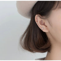 silver stud earrings set with multiple holes, helix cartilage holes