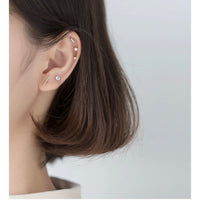 silver stud earrings set on modeling