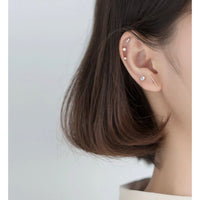 silver stud earrings set on modeling